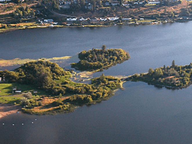 Birds eye view of Scout Island shows the main peninsula extending into the lake with a bridge connecting to the small island and another unconnected island.